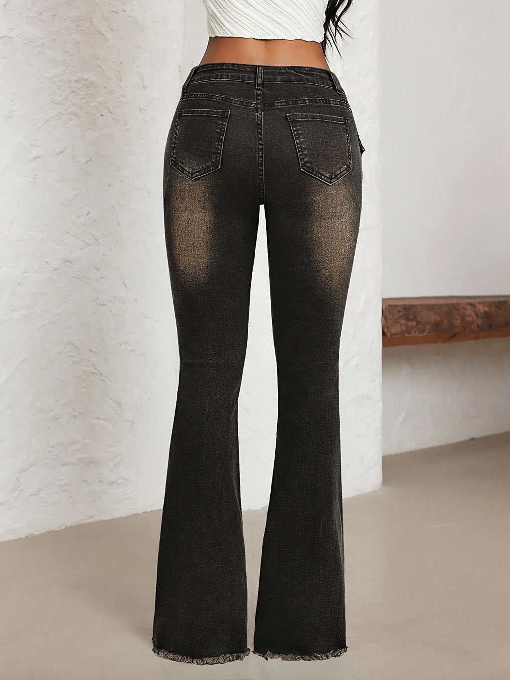 Jeans a vita bassa svasati con fibbia e strappi